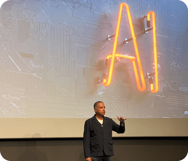 Rajeev speaking at an AI conference